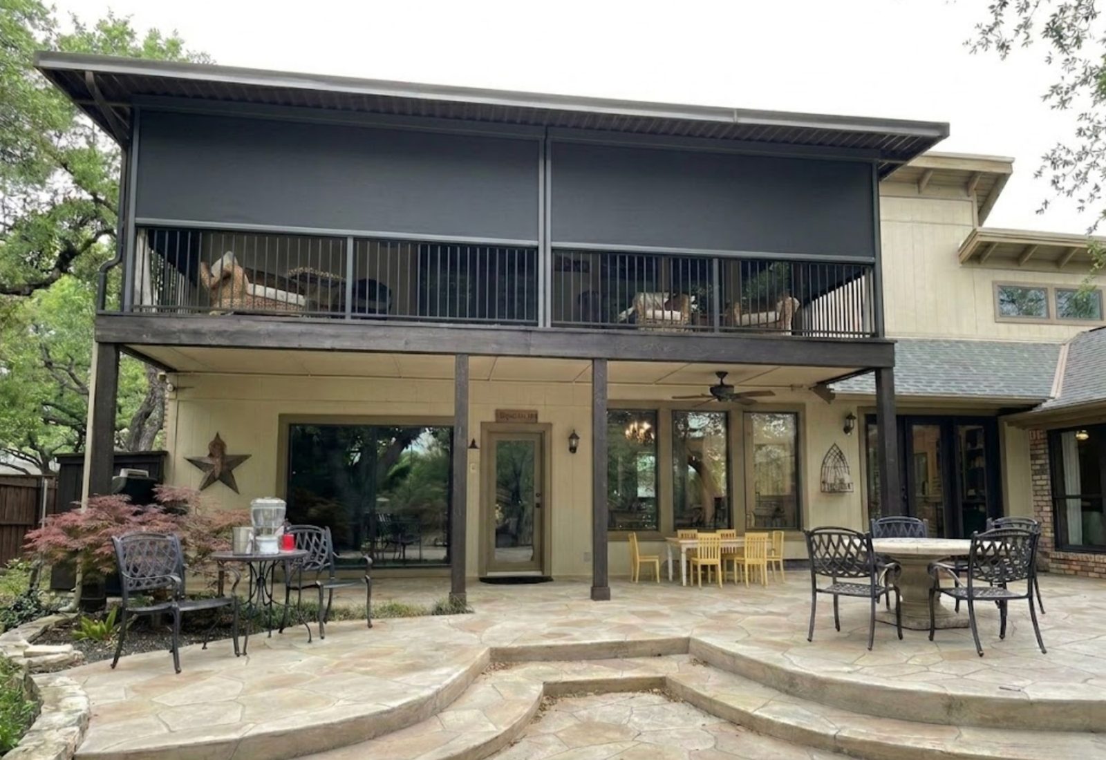 Motorized SunPro patio shades deployed on a Colleyville home, blocking the Texas afternoon sun