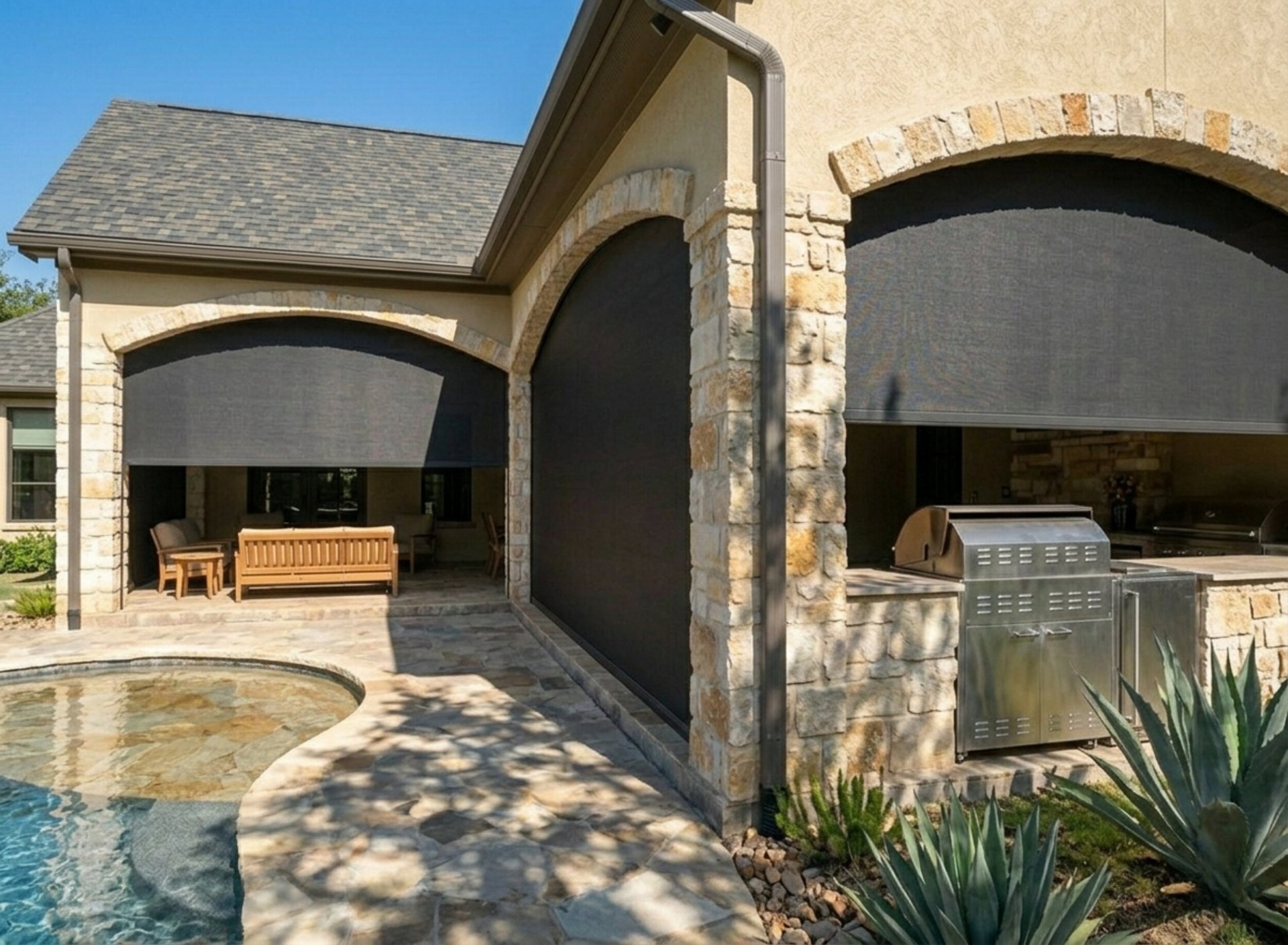 Flower Mound outdoor kitchen with motorized SunPro patio shades deployed over the grill zone