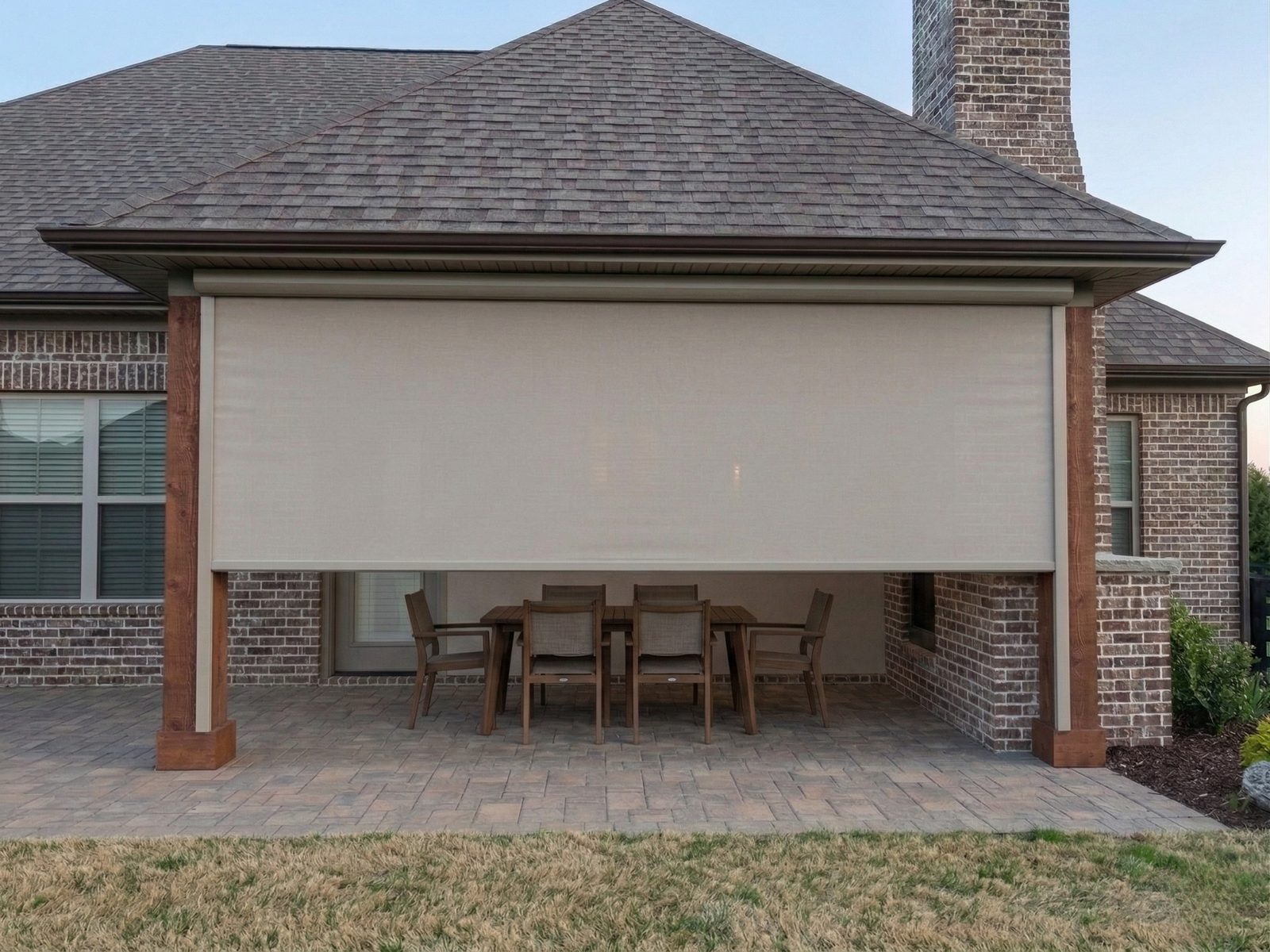 Covered brick patio with motorized SunPro patio shades over a dining table in Keller, Texas
