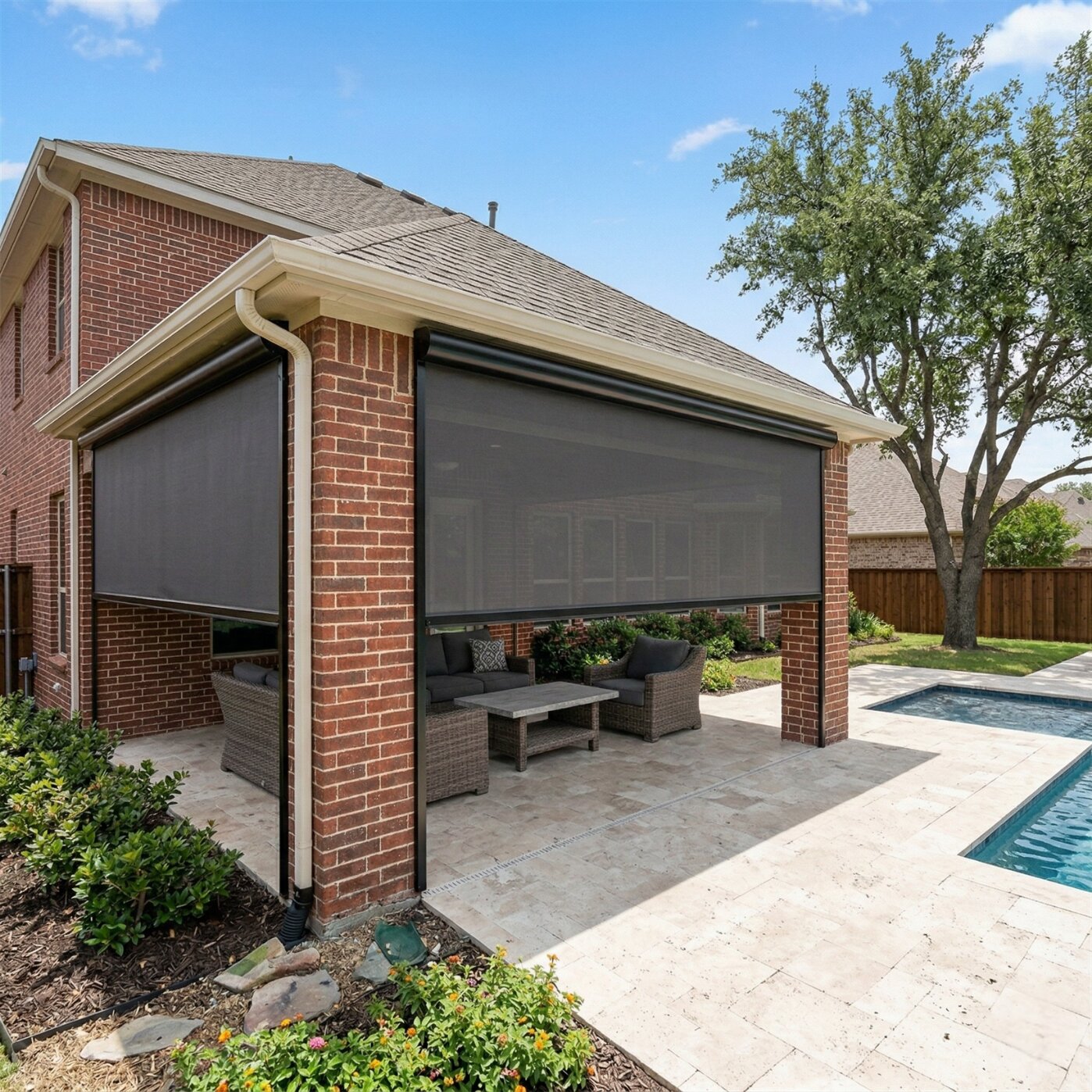 Two panel motorized patio shades on brick home in Benbrook Texas