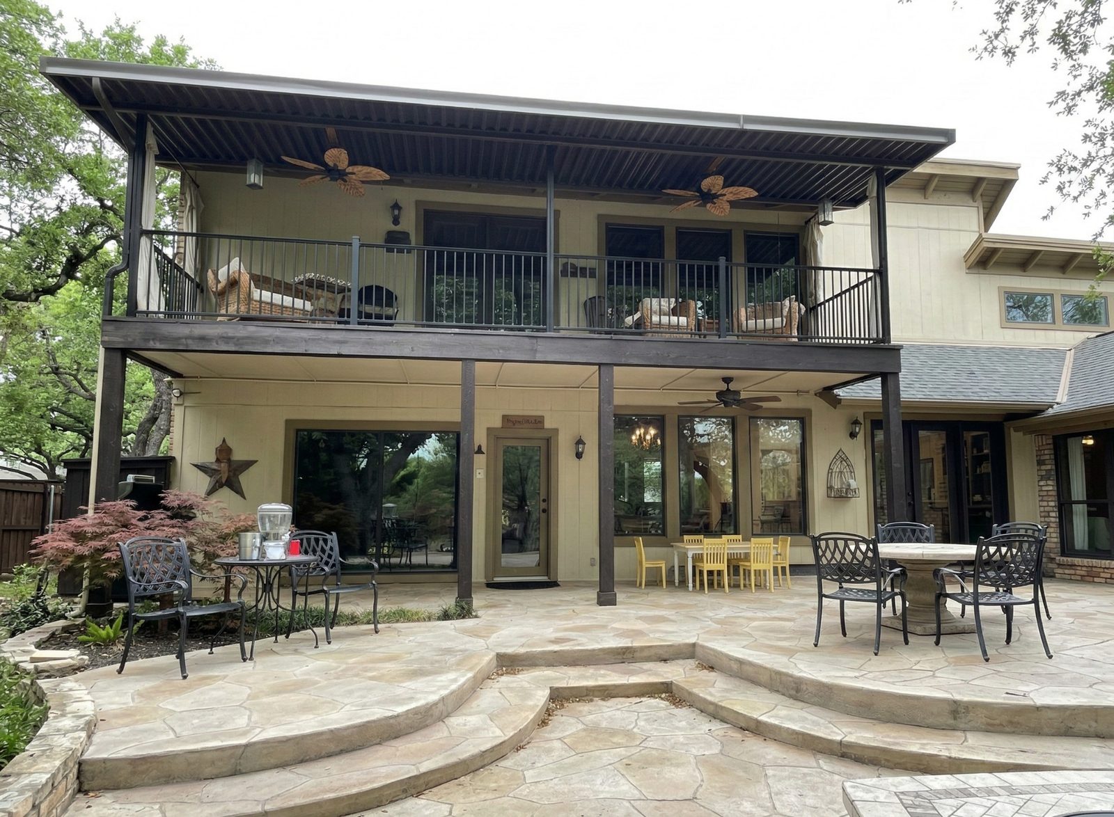 Two-story patio shades retracted on upper deck in Colleyville Texas