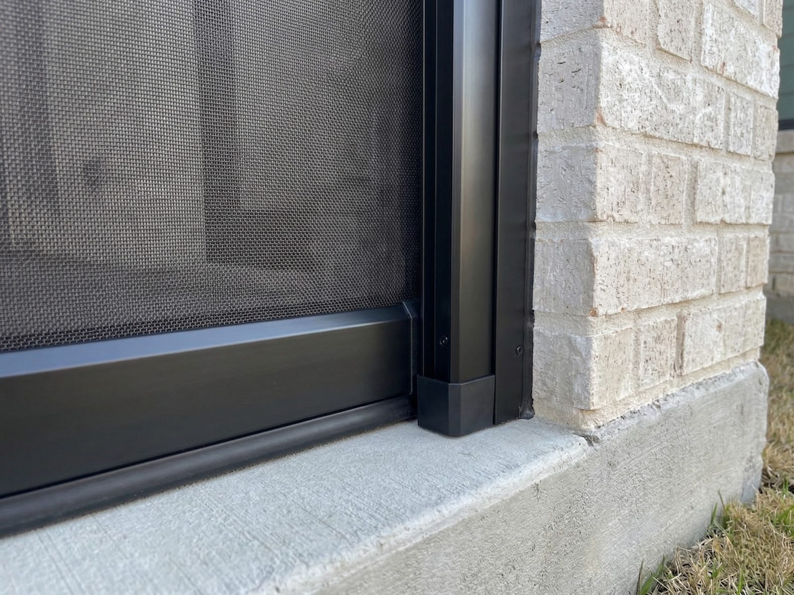 Close-up of patio screen track hardware in Grapevine Texas