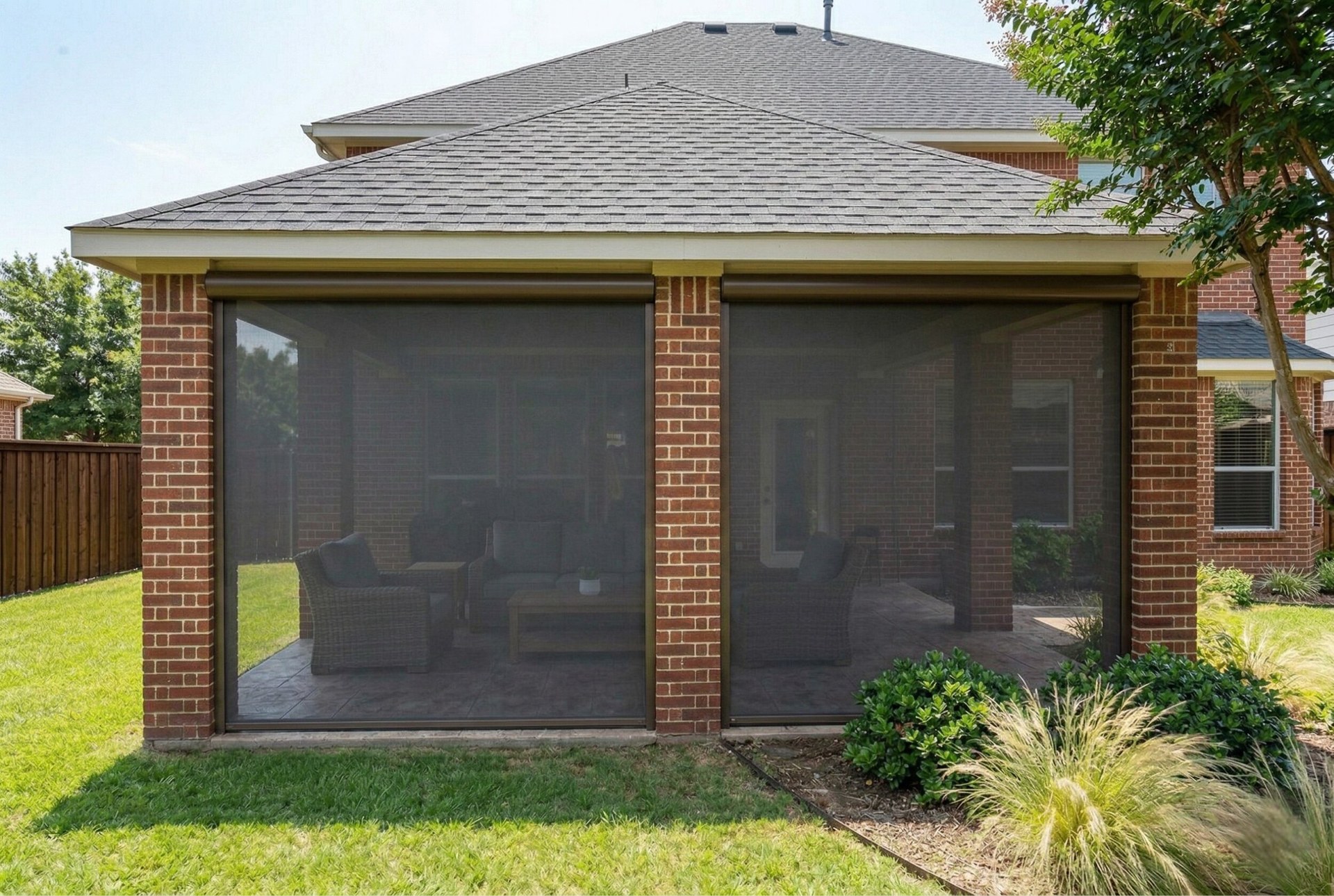 Motorized patio shades deployed on brick home in Keller Texas