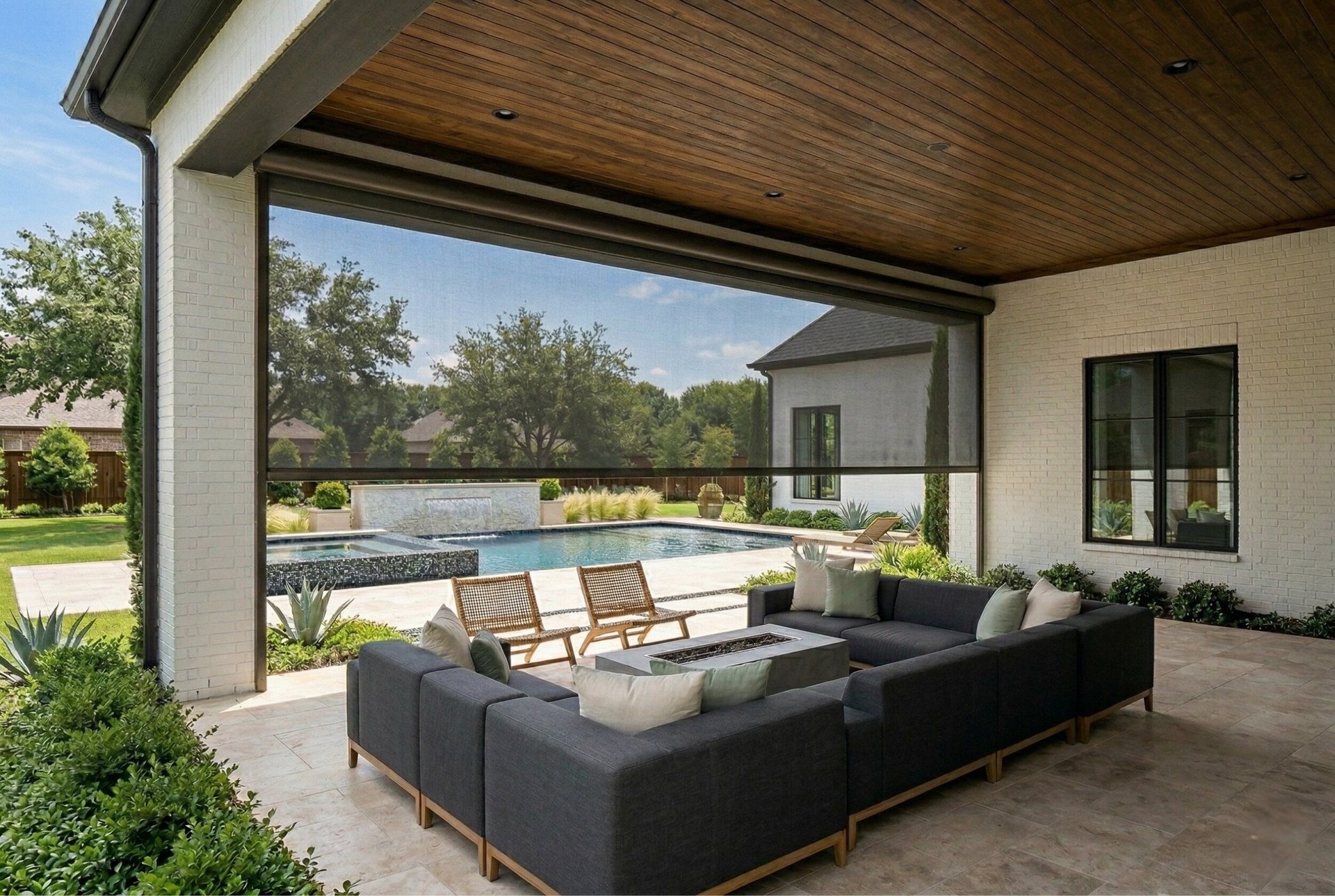 Motorized patio shade partially deployed on luxury poolside patio in Southlake, Texas